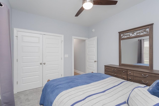 bedroom with ceiling fan, a closet, and carpet flooring