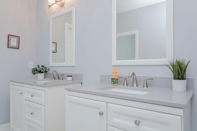 bathroom with two vanities and a sink