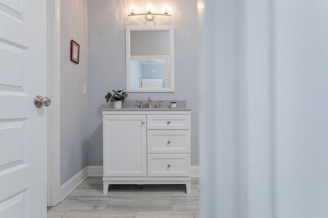 bathroom with baseboards and vanity