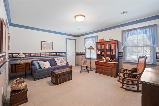 interior space featuring visible vents, wainscoting, carpet flooring, and crown molding