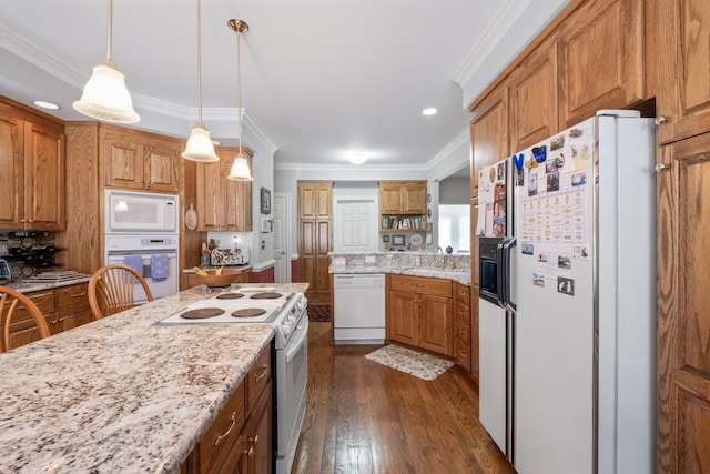 kitchen featuring dark wood finished floors, pendant lighting, ornamental molding, light stone counters, and white appliances