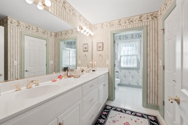 full bathroom with toilet, a sink, wallpapered walls, a shower stall, and tile patterned flooring