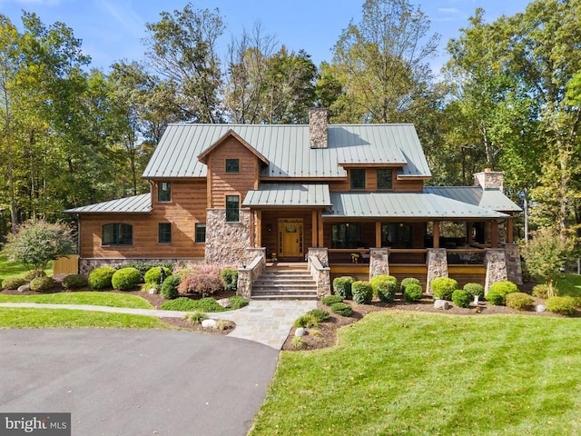 view of front of property with covered porch and a front lawn