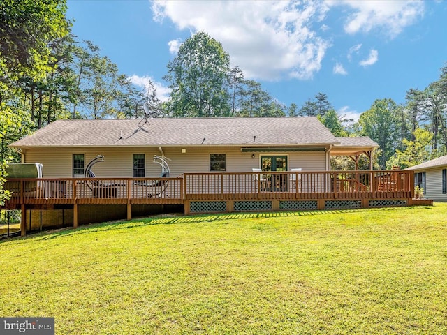 rear view of property featuring french doors and a lawn