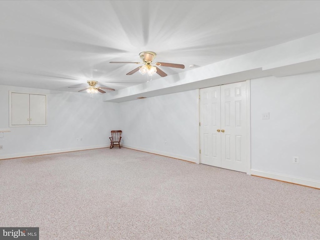 basement with carpet and ceiling fan