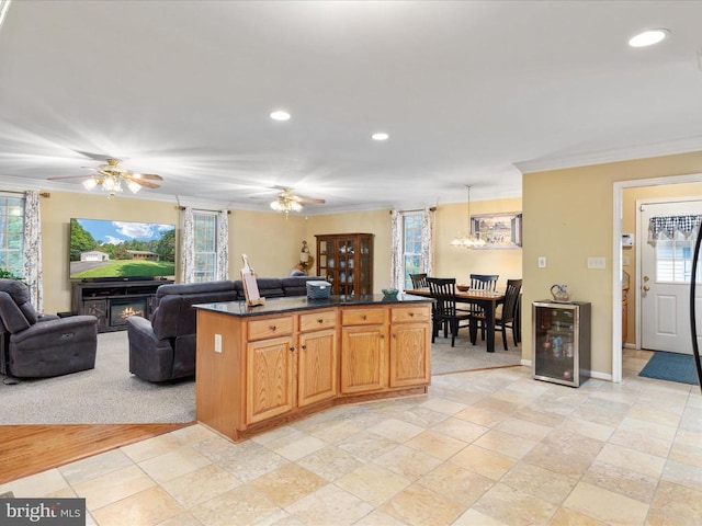 kitchen with wine cooler, crown molding, and a wealth of natural light