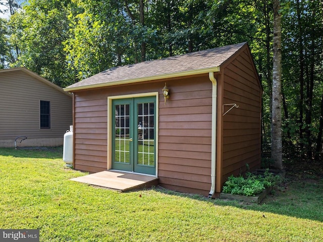 view of outbuilding featuring a yard