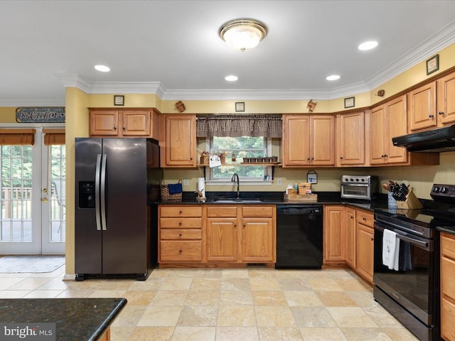 kitchen featuring dark stone countertops, sink, ornamental molding, and black appliances