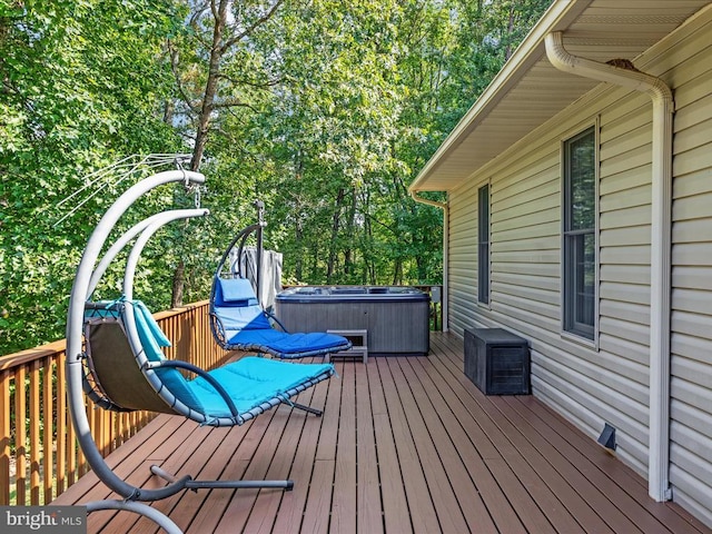 wooden deck with a hot tub