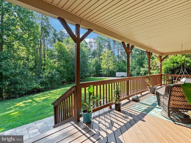 wooden deck featuring a lawn