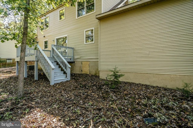 view of side of home with a wooden deck