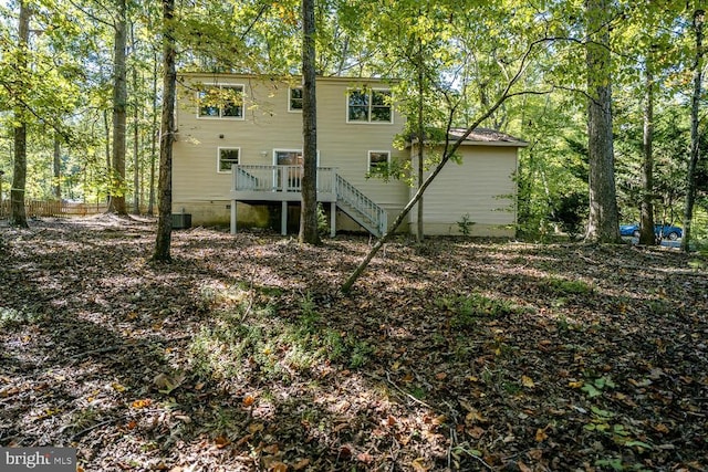 back of property with a wooden deck and central AC unit