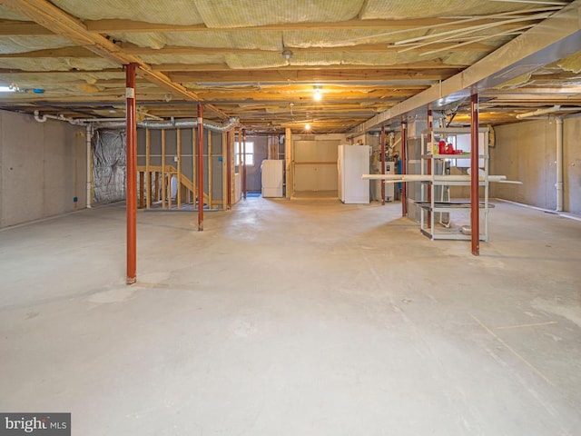 basement featuring freestanding refrigerator