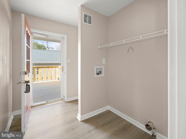 laundry area featuring laundry area, baseboards, visible vents, wood finished floors, and hookup for a washing machine