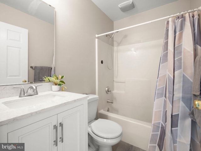 bathroom featuring shower / bath combo, visible vents, vanity, and toilet