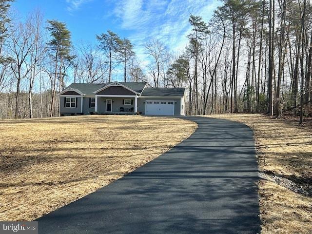 single story home with a garage and a front lawn