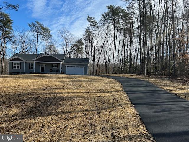 view of front of house with a garage and a front lawn