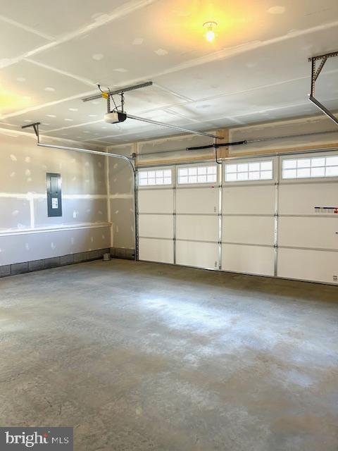 garage featuring a garage door opener and electric panel