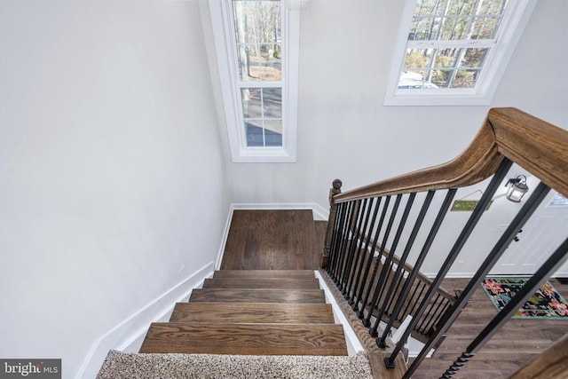 stairs with wood finished floors and baseboards