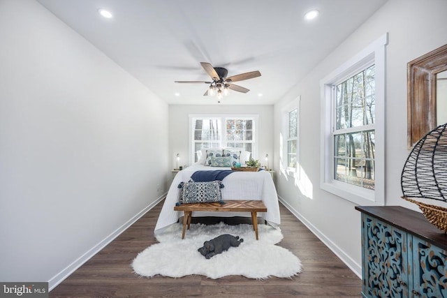 bedroom with recessed lighting, multiple windows, baseboards, and wood finished floors