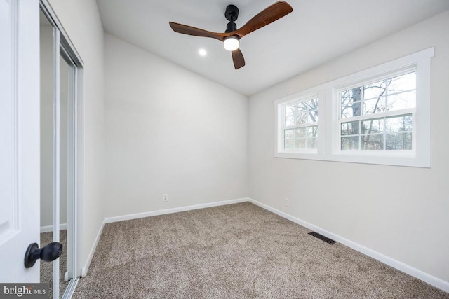 unfurnished bedroom featuring baseboards, visible vents, ceiling fan, carpet flooring, and a closet