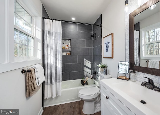 full bath featuring shower / bath combination with curtain, vanity, wood finished floors, and toilet