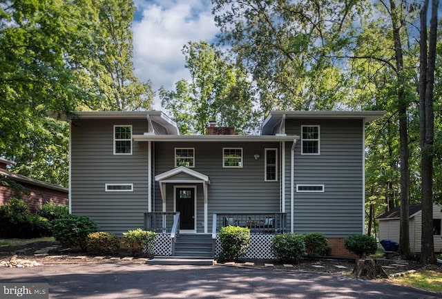 split level home with a chimney