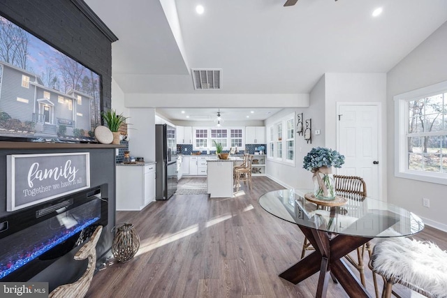 dining area with visible vents, ceiling fan, baseboards, and wood finished floors