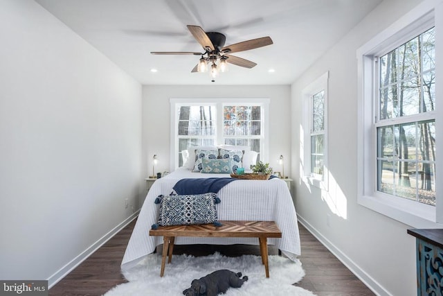 bedroom with multiple windows, recessed lighting, wood finished floors, and baseboards