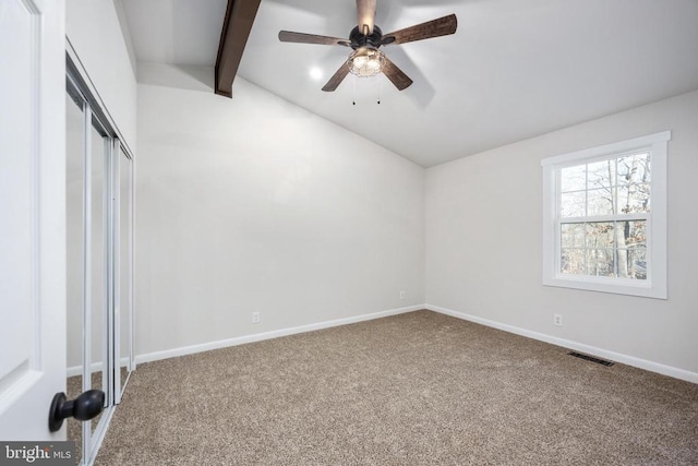 unfurnished bedroom with vaulted ceiling with beams, carpet flooring, visible vents, baseboards, and a closet