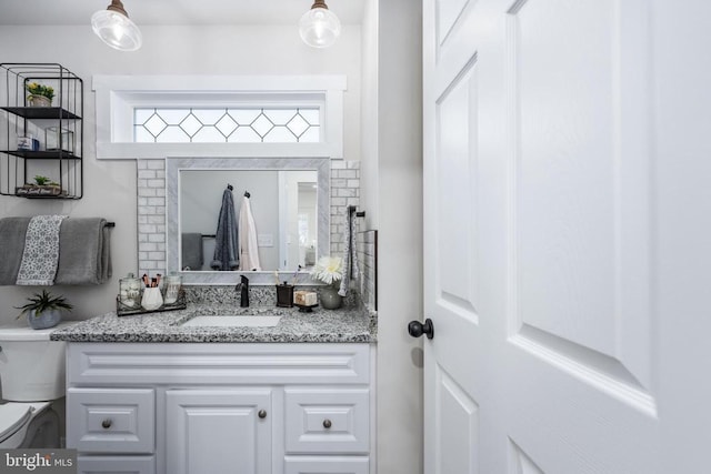 bathroom with vanity and toilet