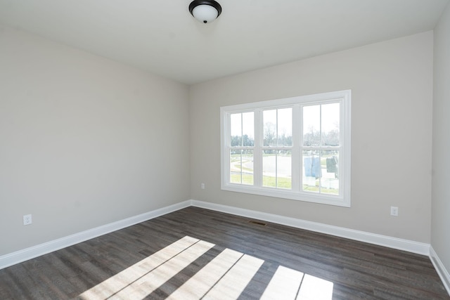 unfurnished room featuring dark wood-type flooring