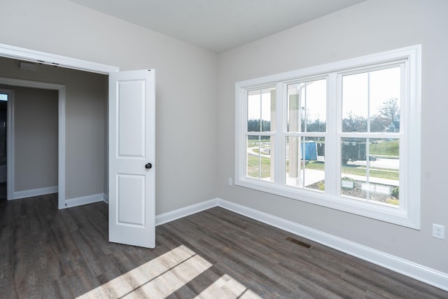 spare room featuring dark hardwood / wood-style flooring