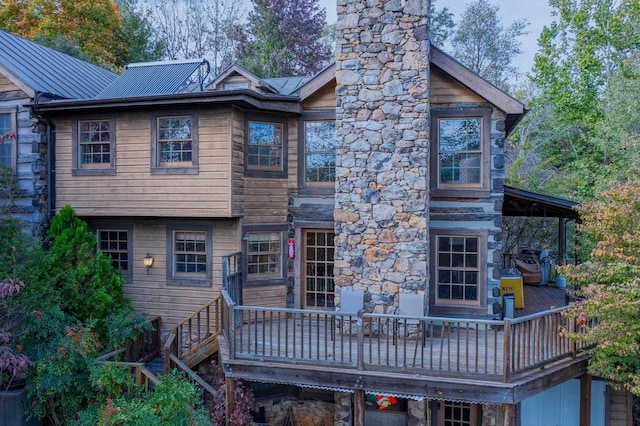 rear view of property with a wooden deck