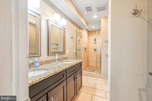 bathroom featuring vanity, tile patterned floors, and a shower with door