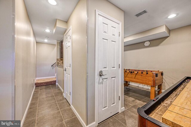 hall with dark tile patterned flooring