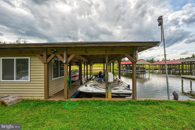 dock area with a water view and a lawn