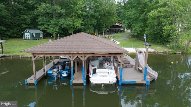 dock area featuring a yard, a water view, and boat lift