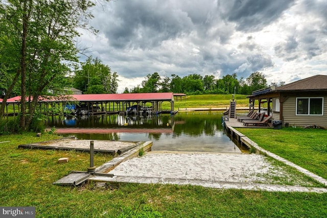 view of property's community with a water view, a dock, and a lawn