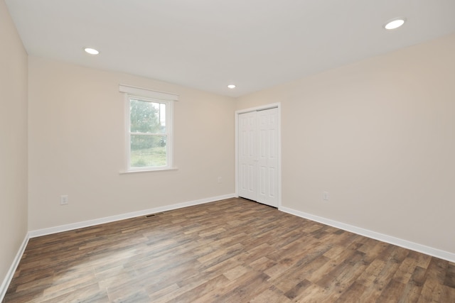 spare room with dark wood-type flooring