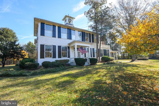 colonial-style house with a front yard