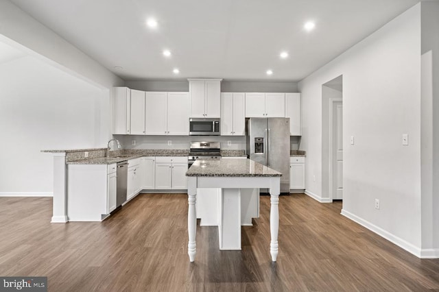 kitchen with white cabinetry, appliances with stainless steel finishes, and stone countertops