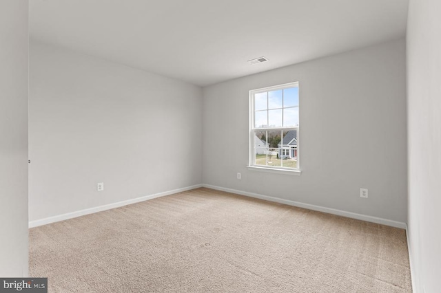 spare room with light colored carpet