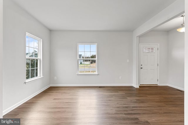 empty room featuring dark hardwood / wood-style flooring