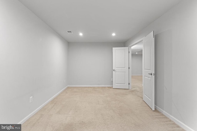 unfurnished room featuring light colored carpet