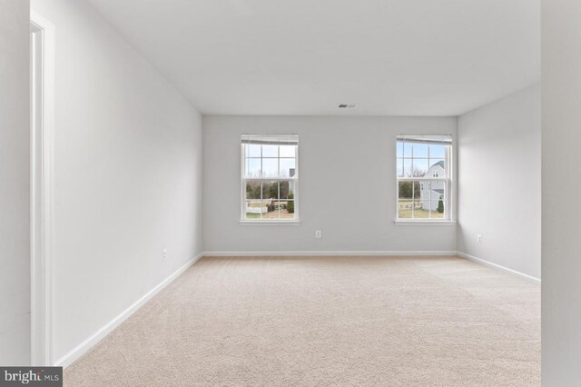 carpeted empty room featuring a healthy amount of sunlight