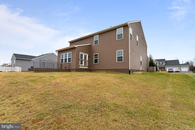 rear view of house featuring a lawn