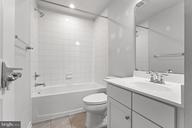 full bathroom with tile patterned flooring, vanity, toilet, and tiled shower / bath