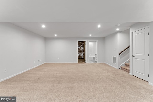 basement featuring light carpet