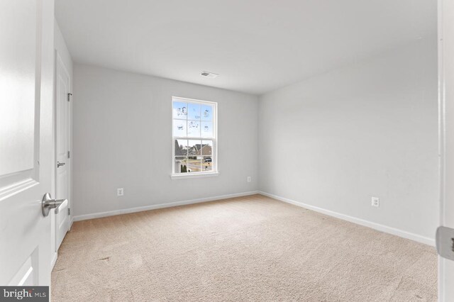 unfurnished room with light carpet